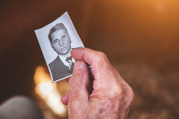 istock Old man's hand holding a photograph 939104012