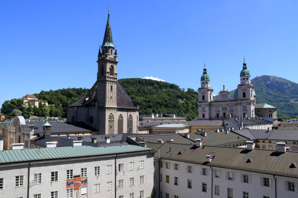 Franciscan Church and the Cathedral of Saints Rupert and Vergilius (Salzburger Dom) in Salzburg, Austria Salzburg, best known for being the birth place of the composer Wolfgang Amadeus Mozart, the setting for the musical movie "The Sound of Music" and for it's baroque architecture. The old town is one of the best-preserved city centers in Europe, therefore it became an UNESCO World Heritage in 1997.
The fresco shown on the building is a sundial of the late medieval times. gaisberg stock pictures, royalty-free photos & images