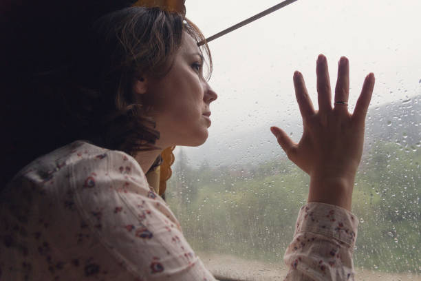 istock Pensive girl at the train window. A train 939113984