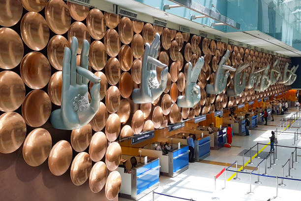 Scene of Indira Gandhi International Airport decorated with hand sign staute. New Delhi, India - April 8, 2017: Beautiful decoration of passenger arrival check-in counters at Indira Gandhi International Airport, taken photo by mobile camera. india airport stock pictures, royalty-free photos & images