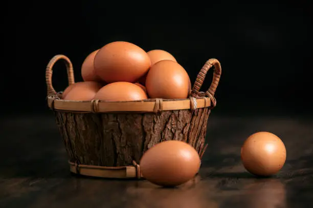 Photo of eggs in and out of a basket