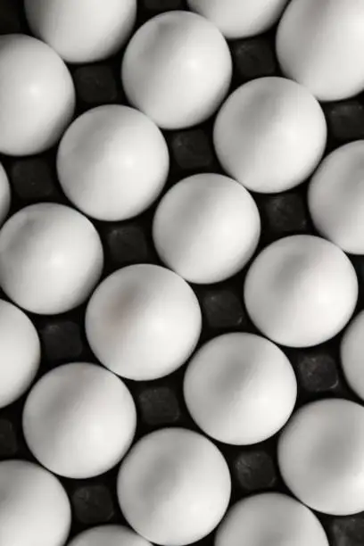 Photo of eggs in a black carton tray