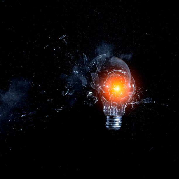 istock Close-Up Of Broken Light Bulb Against Black Background 939118412