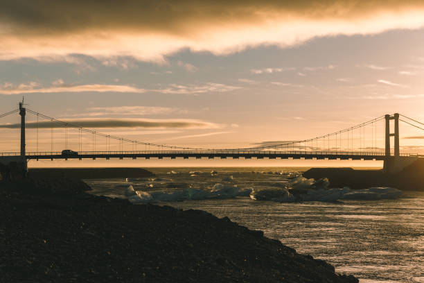 istock car on bridge above river with icebergs at sunset, iceland 939118908