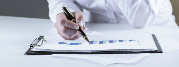istock closeup.business woman analyzing marketing graphics 939118970