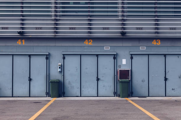 The National Autodrome of Monza - Pit Stop Lines and Garage Area in an Empty Race Track - Monza Circuit in Lombardy - Italy. The National Autodrome of Monza - Pit Stop Lines and Garage Area in an Empty Race Track - Monza Circuit in Lombardy - Italy pitstop stock pictures, royalty-free photos & images