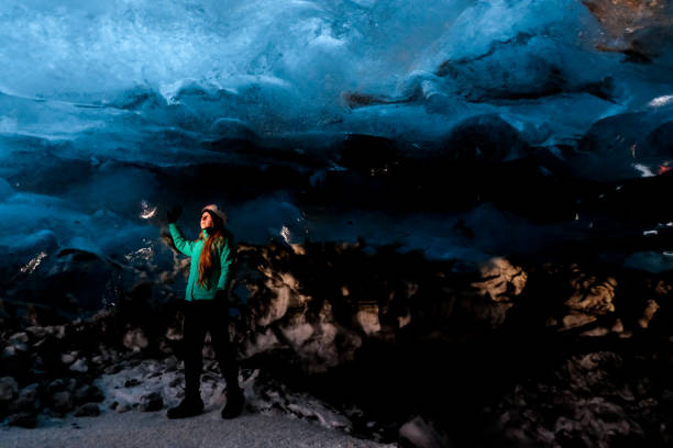 istock Woman standing in ice cave after climbing 939119054