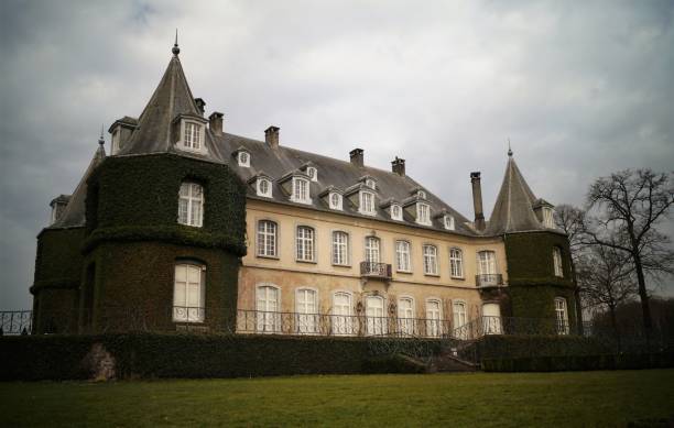 La Hulpe, Belgium - March 26, 2018: The Chateau de La Hulpe is a 19th-century French style castle in the Wallonia province of southern Belgium outside Brussels. The château was completed in 1842 in Flemish Neo-Renaissance style, flanked by towers at each of the four corners. In the late 19th century, the house and estate were acquired by Ernest Solvay.