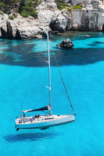Picturesque bay with sailing boat, Menorca island, Spain