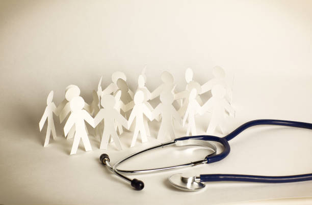 istock stethoscope and paper men on the table 939124796