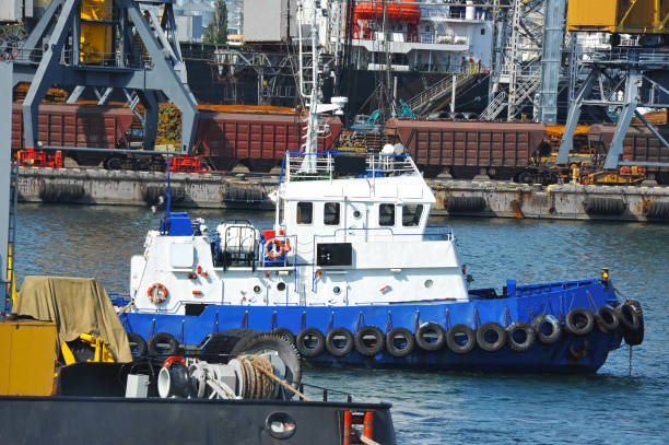 istock Tugboat and port cargo crane 939125146