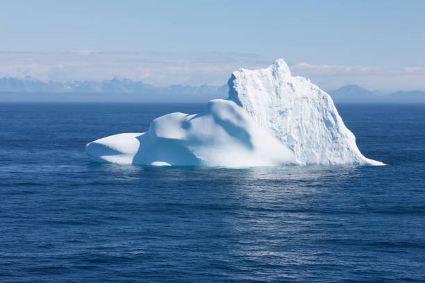 istock Greenland floating iceberg in deep blue ocean water 939125254
