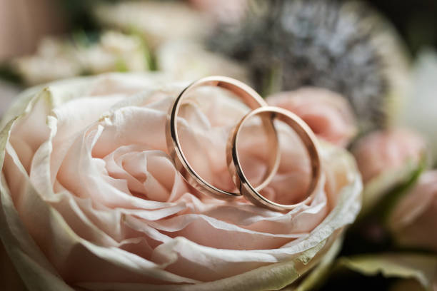 istock wedding rings lie on a beautiful bouquet as bridal accessories 939125312