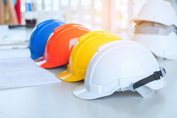 istock Close-Up Of Colorful Hardhats On Table 939125604