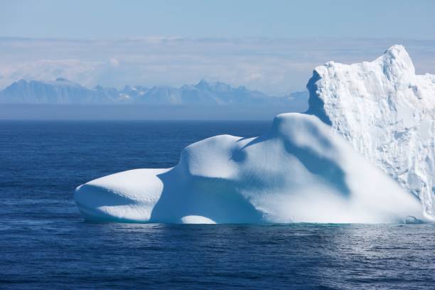 istock Greenland floating iceberg in deep blue ocean water 939125802