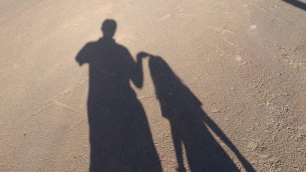 istock Shadow of father daughter 939128694