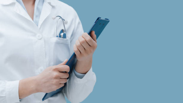istock Professional female doctor posing with a clipboard 939133942