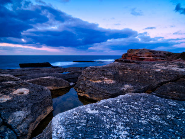 istock Sunset over the rocks with seascape 939134978
