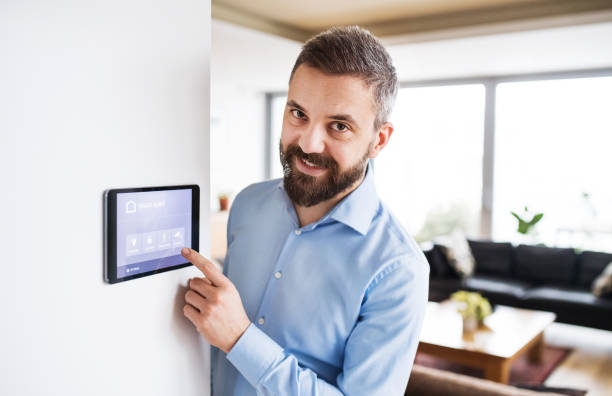 istock A man pointing to a tablet with smart home screen. 939135616