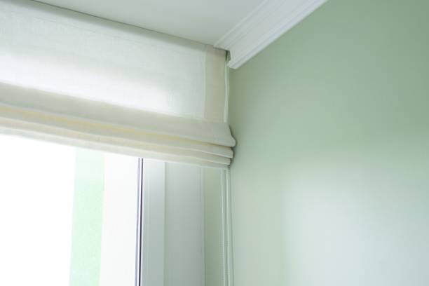 istock Roman curtains in the interior, from natural light linen 939144280