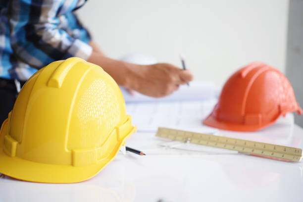 istock working of Architect sketching a construction project at site construction work on his plane project 939145148