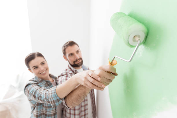 istock Loving couple painting together 939145890