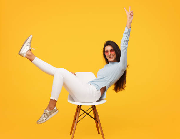 istock Excited hipster girl posing on chair 939148566