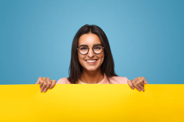 Cheerful woman with cardboard banner