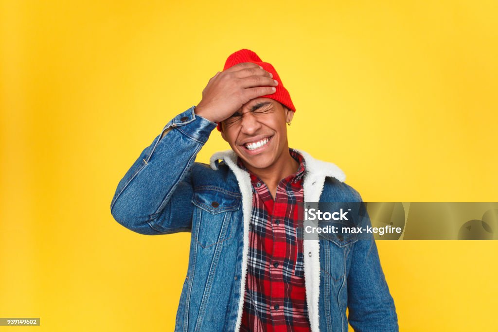 Trendy guy upset with forgetting things Stylish black man holding hand on head and frowning in annoyance of forgetting important thing. Reminder Stock Photo