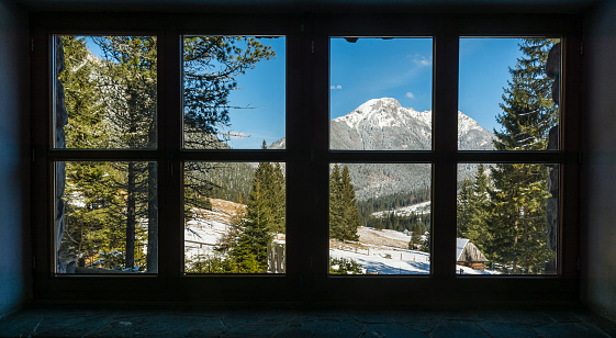 Kominiarski Wierch peak and Chocholowska clearing seen in the spring season from a window in a mountain hut.