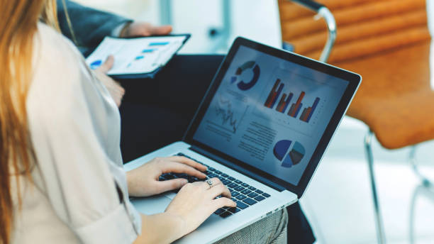 istock business team working on laptop with financial schedules in the workplace 939150416