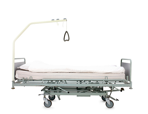 Surgical bed on wheels over white background