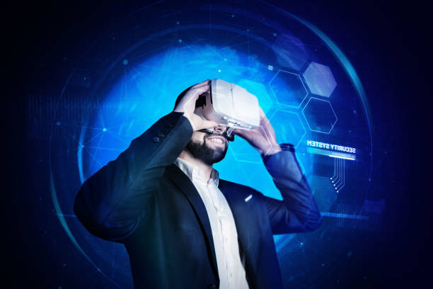 istock Cheerful young man smiling while putting on virtual reality glasses 939153632