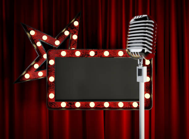 istock Stage Microphone with Blank Board in front of red Curtain. 939155006