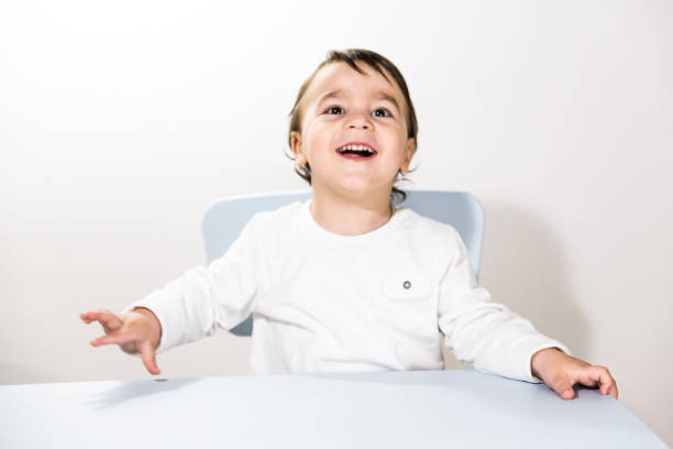 istock Cute little boy sitting at the table 939155372