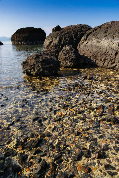 istock Volcanic rocks in the sea 939155482