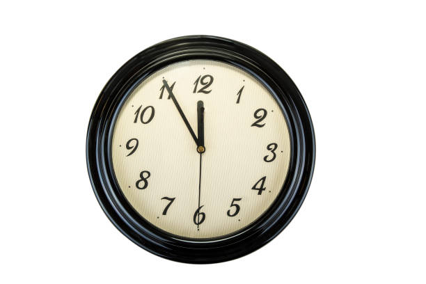 istock Clock on the wall. Time concept. Five to twelve, it's  almost late 939159108