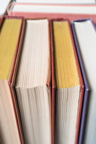istock Book stacking open book hardback books on wooden table. 939159776