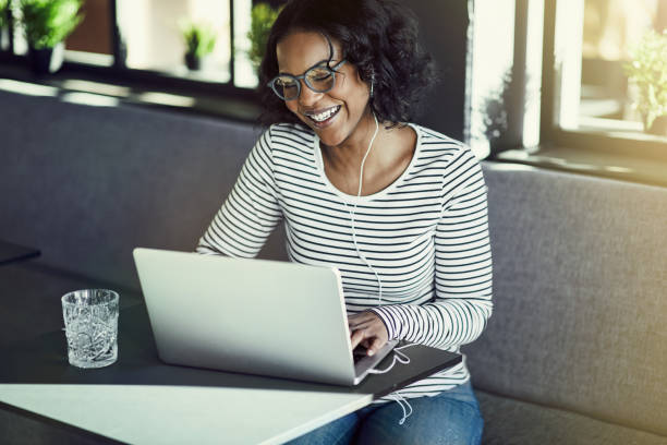 istock Smiling young African woman enjoying an online chat 939160554