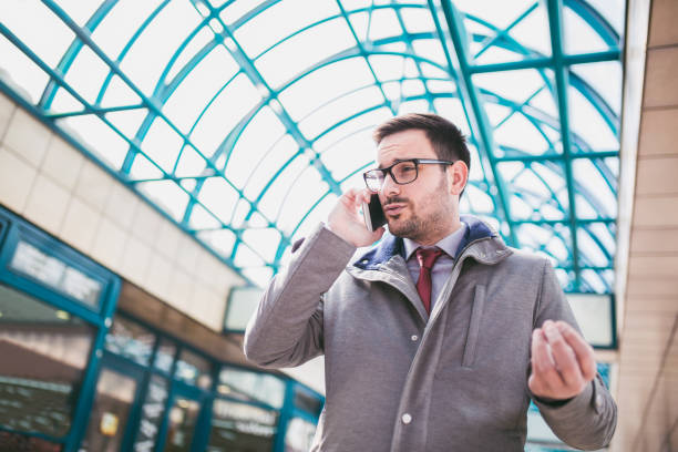istock Young caucasian man holding smartphone for business work. 939162814