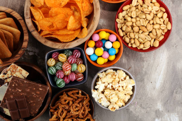 istock Salty snacks. Pretzels, chips, crackers in wooden bowls. 939163592