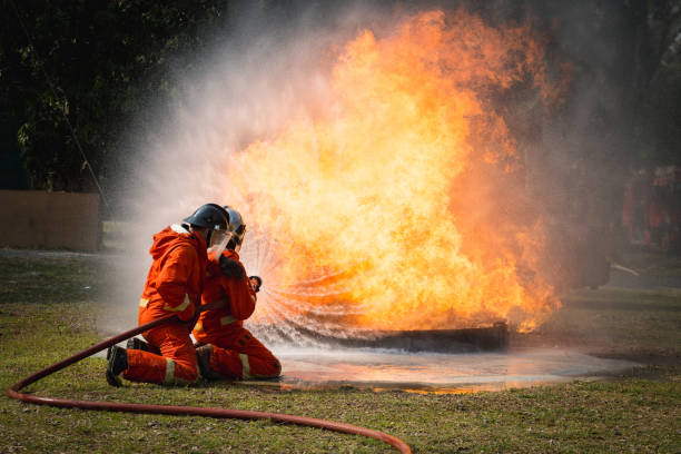 istock Firefighters training, Team practice to fighting with fire in emergency situation.Spray water to the flame 939164512