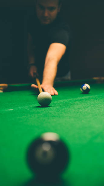 istock Billiard balls in a green pool table 939168104