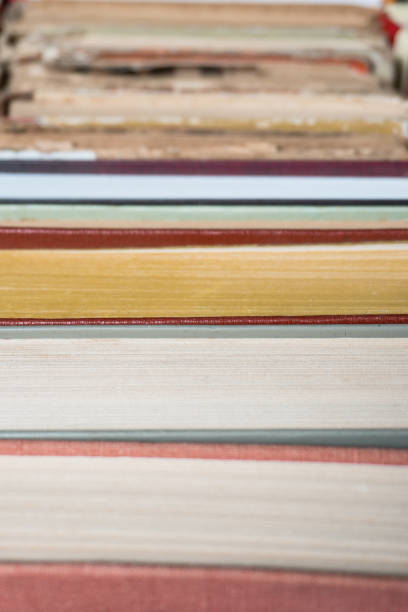 istock Book stacking open book hardback books on wooden table. 939168530