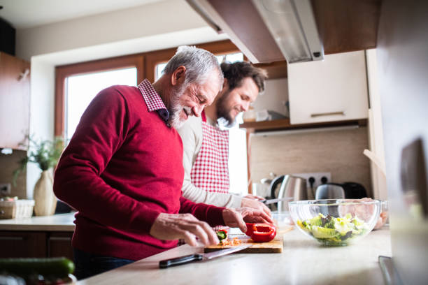 istock Hipster son with his senior father cooking in the kitchen. 939169530