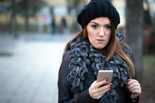 istock Woman texting on mobile phone on the street 939171832