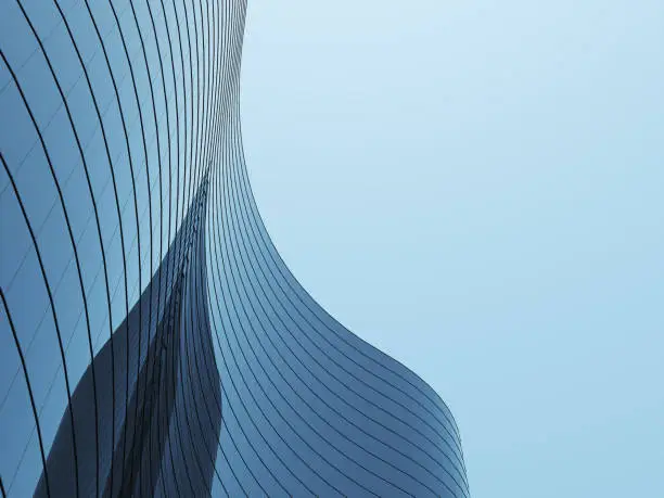 Photo of 3D stimulate of high rise curve glass building and dark steel window system on blue clear sky background,Business concept of future architecture,lookup to the angle of the corner building.