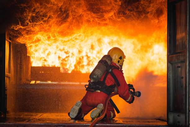 istock Firefighters training, Team practice to fighting with fire in emergency situation.Spray twist water to the flame 939173318
