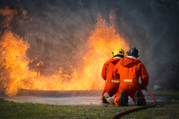 istock Firefighters training, Team practice to fighting with fire in emergency situation.Spray twist water to the flame 939173336