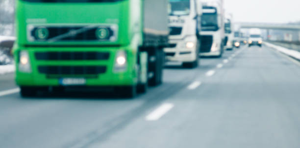 istock Trucks and cars driving on highway blurry image 939181268